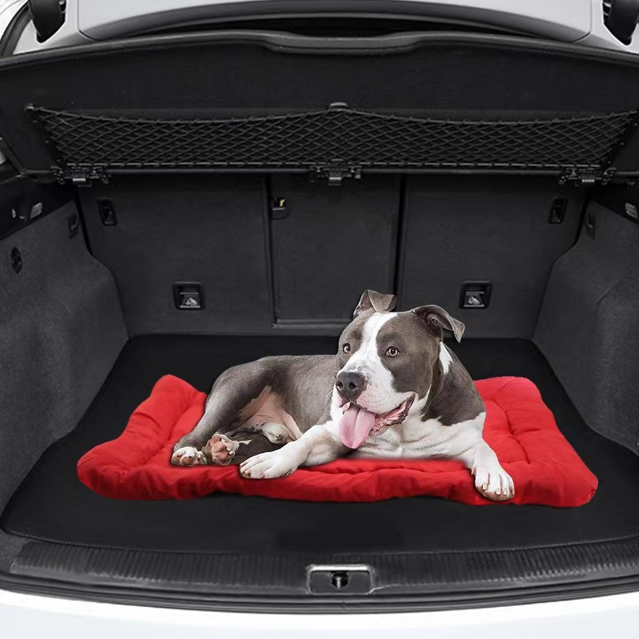 Roll-Up Water-Resistant Travel Dog Bed – dog relaxing on the red travel bed in an SUV cargo area